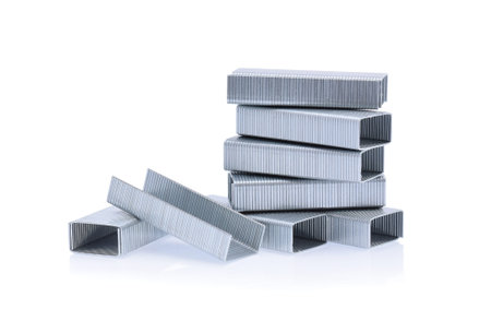 Stack of metal staples isolated on white background.