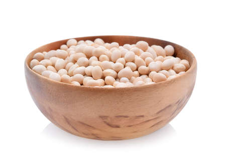Soybeans in a wooden cup isolated on white background.の写真素材