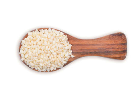 Top view of white sesame in wooden spoon on white backgroundの写真素材