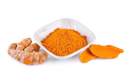 Turmeric roots with turmeric powder on white backgroundの写真素材