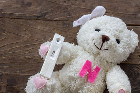 Pregnant test of teenage happy on wood backgroundの写真素材