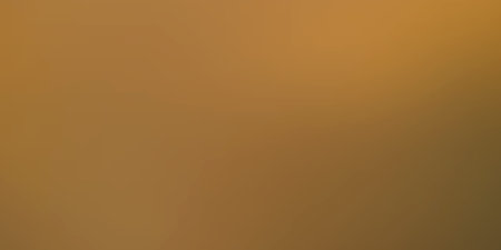 This image captures a soft, warm amber glow that fills the frame. The gradient transitions from a...