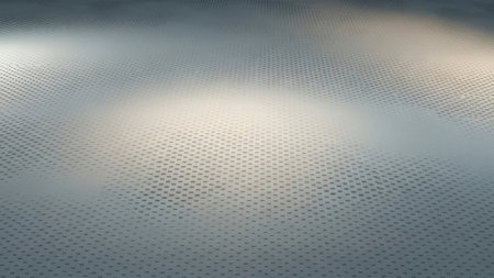 This image showcases an abstract view of a perforated metal surface. The metal features a series of evenly spaced, small circular holes, creating a repetitive pattern that extends across the entire frame. The lighting casts subtle shadows, adding depth and dimension to the otherwise flat surface. The overall aesthetic is minimalist and industrial, with a focus on texture and pattern.の素材
