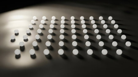 This image features a series of uniformly arranged circular dots, each emitting a soft glow. The dots are organized in a grid-like pattern, creating a visually appealing and symmetrical design. The background is dark, which accentuates the luminosity of the dots, making them stand out prominently. The overall effect is a sense of depth and focus on the illuminated points.の素材