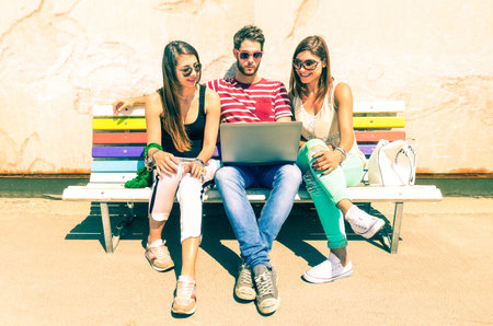 Group of friends using laptop on travel holiday in sunny summer day - Teenagers on vacation with...