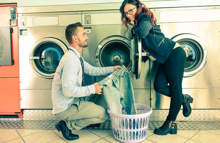 Young attractive couple doing laundryの写真素材