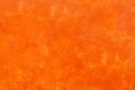 Orange rustic background - Golden bronze sponged paint wall - Autumnal color panelの写真素材
