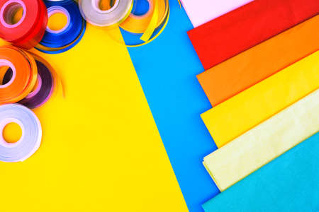 Ribbons and paper for gifts and packages - Colorful collection of stationery items top view flat lay imageの写真素材