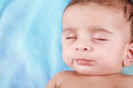 Sleeping Baby Boy with blue backgroundの写真素材