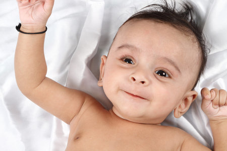 Smiling Baby on white satin background