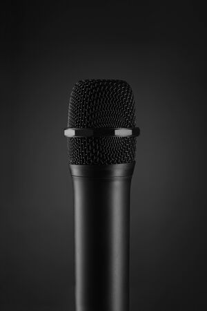 Wireless Black microphone on dark grey backgroundの写真素材