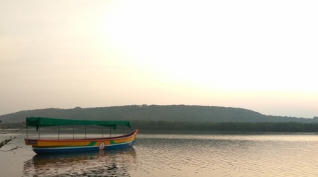 Boat anchored in river at dawn. Photograph clicked moments before sunrise.の写真素材