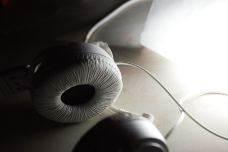 A white colored music headphone against lightの写真素材