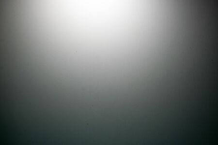 Simple white background with texture. The background is lit using white light and shades of gray. Background has empty space for pictures and text.の写真素材