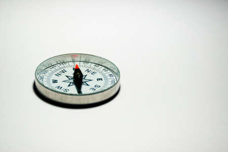 A compass pointing North on a plain white background with empty space for textの写真素材