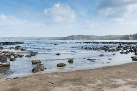 Panoramic view of beautiful rocky beach of Velneshwar situated in Maharashtra, India. The landscape photograph is clicked on a summer morning.の写真素材