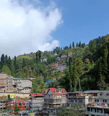 Panoramic landscape view of beautiful scenic mountainous town of Darjeeling from the road on bright day. Surrounded by lush green Himalayas, Darjeeling is a famous tourist place in West Bengal, Indiaの写真素材