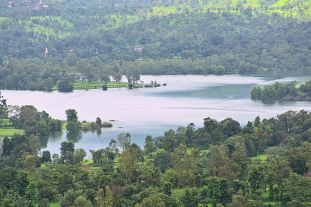 Panoramic view of beautiful Koyna river surrounded by lush green mountains at Tapola. It is a popular tourist destination for monsoons and winters in Satara district of Maharashtra, India.の写真素材