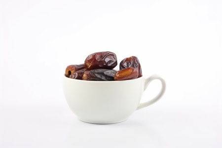 Dates fruit in a white cup on a white background, isolatedの素材