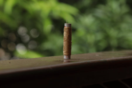 A sewing thread placed on a dusty floor