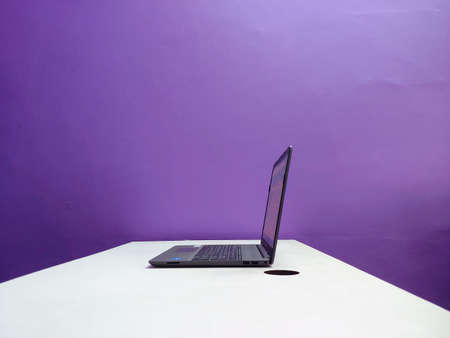 A working laptop on a table in the officeの写真素材