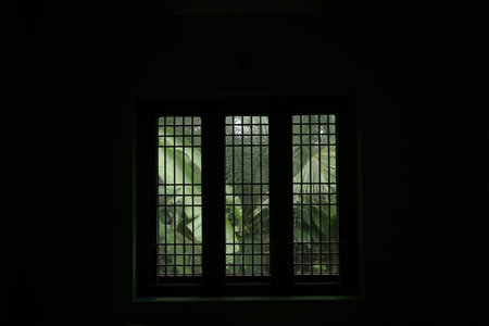 A window in a dark closed room