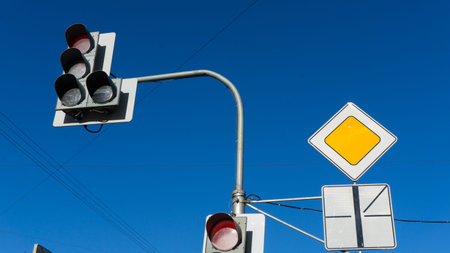 Traffic light with red light against the blue sky. Shallow depth of field.