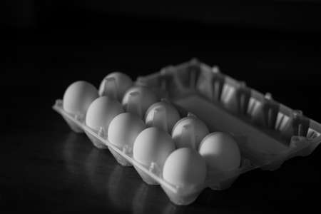 white chicken eggs on a dark backgroundの写真素材