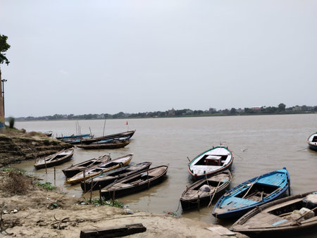 Long tail boat parked on the water and near Ramnagar fort varanasi india. this is a boat ride to see...