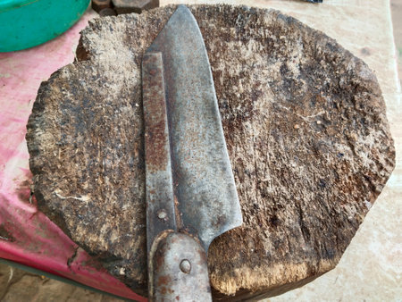 butcher knife and cleaver on a wooden block at a meat shop in an Asian market. A butcher block with knife and meat clove at a shop in India.の写真素材