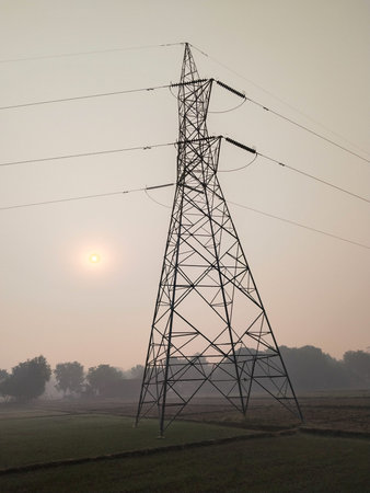 morning in Agricultural Field overlooking High Tension Electric Tower. Electricity concept, Close up...