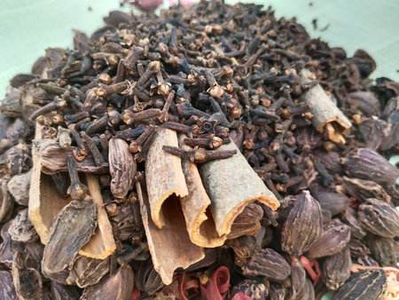 Variety of spices on bay leaf, ingredients for garam masala with Indian Chef statue, indian spice...