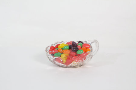 Glass bowl filled with candies of different colors,