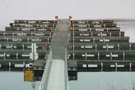 Marina empty of boats during the early winter season in North America  Boat slips empty.