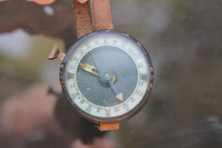 Old Military compass hanging on leather strapの写真素材
