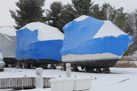Shrink wrap on boats, on dry land during the winter season as protection against elements.の写真素材