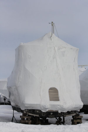 Plastic shrink wrap on boat, to protect boat and interior of boat from the winter elements.