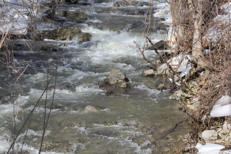 Water melt-off swiftly running down a rocky slope during a seasonal melt.