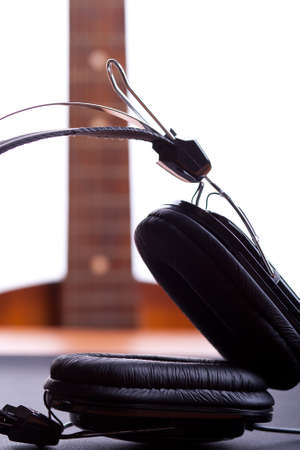 headphones close up in focus and guitar on backgroundの写真素材