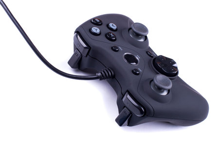 black gamepad close up isolated on a white background and black cable goes out of