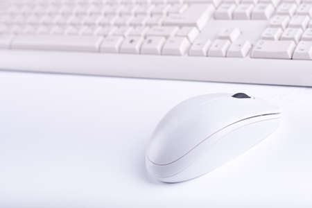 white mouse close up with keyboard on white backgroundの写真素材
