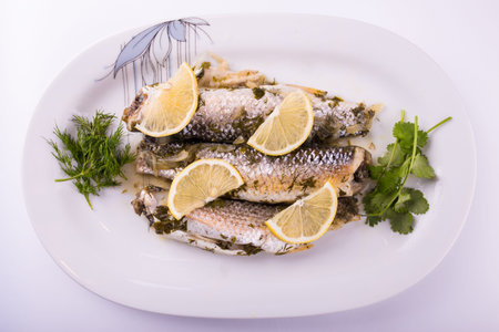 three mullet stew with lemon and grass on a plateの写真素材