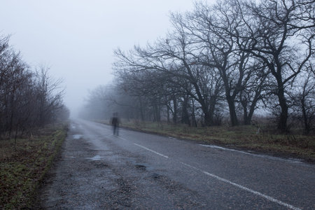 strange man walk down the road at the foggy dayの写真素材