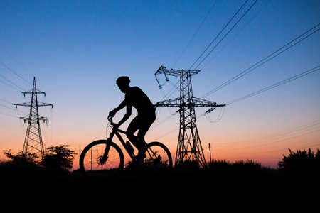 Silhouette of a biker on an eveningの写真素材