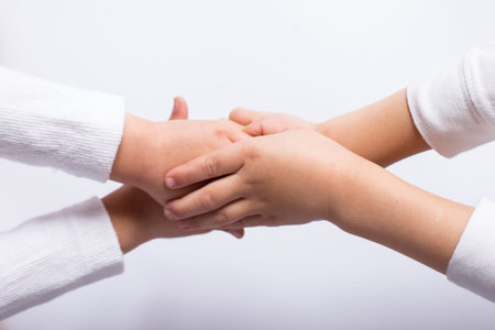 reconciliation between children, kid's hands on each other