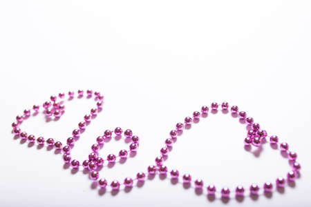 Hearts shaped purple necklace on a white backgroundの写真素材
