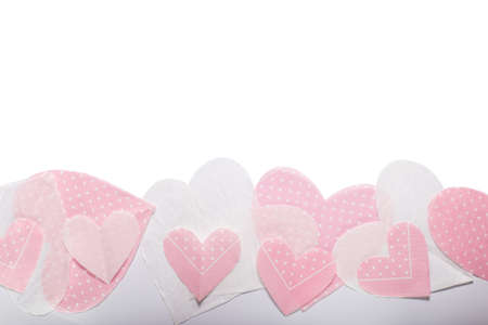 Background for Valentine's Day, pink and white napkins heart shaped with copy spaceの写真素材