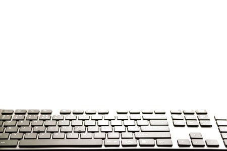 Black keyboard in a front of copy space. Keyboard close up on a front of monitor.