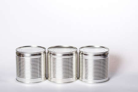 Three metal cans with preservation, with shadows on a white background. Cans with preservation with copyspace on white.の写真素材