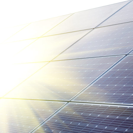 Sun shining to solar panels close up at sunset time on the solar power station.
